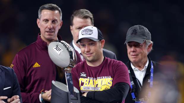 Dec 7, 2024; Arlington, TX, USA; Arizona State Sun Devils head coach Kenny Dillingham looks at the trophy after winning the Big 12 Championship game against the Iowa State Cyclones at AT&T Stadium.