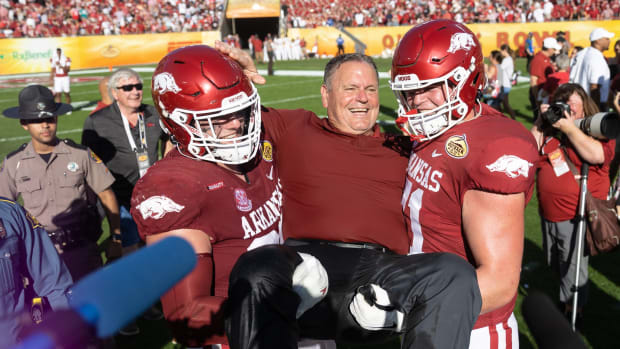 Jan 1, 2022; Tampa, FL, USA; Arkansas Razorbacks head coach Sam Pittman smiles with offensive lineman Ryan Winkel (71) after the game against the Penn State Nittany Lions during the 2022 Outback Bowl at Raymond James Stadium.