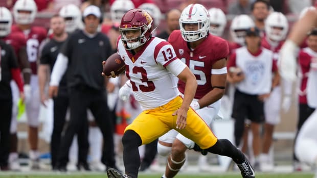 Sep 10, 2022; Stanford, California, USA; USC Trojans quarterback Caleb Williams (13) runs with the football against the Stanford Cardinal during the first quarter at Stanford Stadium.