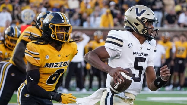 Oct 22, 2022; Columbia, Missouri, USA; Vanderbilt Commodores quarterback Mike Wright (5) runs the ball as Missouri Tigers linebacker Ty'Ron Hopper (8) chases during the second half of the game at Faurot Field at Memorial Stadium.