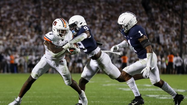 Sep 18, 2021; University Park, Pennsylvania, USA; Auburn Tigers running back Tank Bigsby (4) runs with the ball as Penn State Nittany Lions cornerback Joey Porter Jr. (9) tries the rip the ball away during the fourth quarter at Beaver Stadium. Penn State defeated Auburn 28-20.