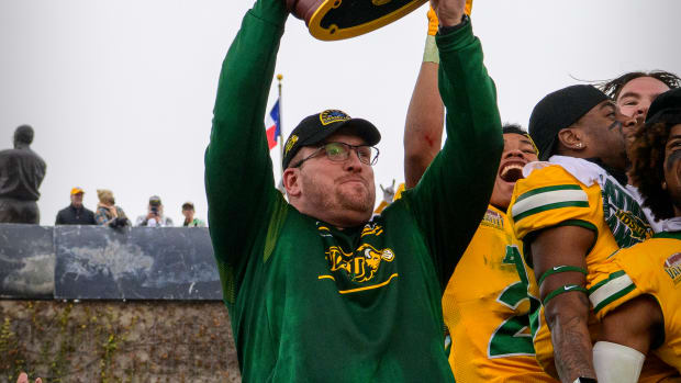 Jan 8, 2022; Frisco, TX, USA; North Dakota State Bison head coach Matt Entz holds up the championship trophy as the North Dakota State Bison team celebrates the win over the Montana State Bobcats in the FCS Championship at Toyota Stadium.