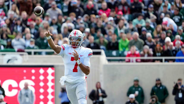 Oct 8, 2022; East Lansing, Michigan, USA; Ohio State Buckeyes quarterback C.J. Stroud (7) throws the ball in the first quarter of the NCAA Division I football game between the Ohio State Buckeyes and Michigan State Spartans at Spartan Stadium.