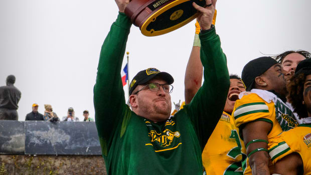 Jan 8, 2022; Frisco, TX, USA; North Dakota State Bison head coach Matt Entz holds up the championship trophy as the North Dakota State Bison team celebrates the win over the Montana State Bobcats in the FCS Championship at Toyota Stadium.