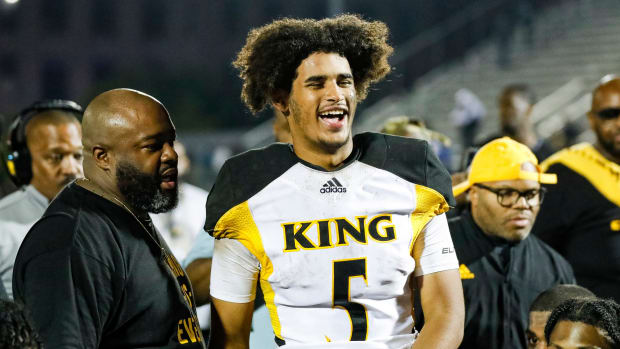 Detroit King quarterback Dante Moore (5) talks to teammates after 28-23 win over Detroit Cass Tech at Cass Technical High School in Detroit on Friday, Sept. 16, 2022.