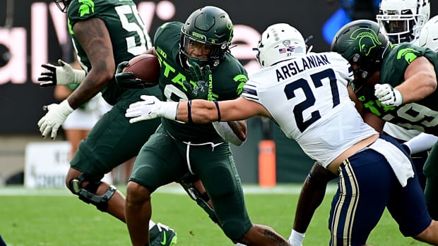 Sep 10, 2022; East Lansing, Michigan, USA; Michigan State Spartans running back Jalen Berger (8) evades Akron Zips linebacker Bubba Arslanian (27) for a first down.