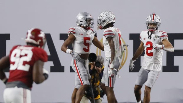 Jan. 11, 2021; Miami Gardens, Florida, USA; Ohio State Buckeyes wide receiver Garrett Wilson (5) celebrates catching a 20-yard touchdown with wide receiver Jameson Williams (6) during the third quarter of the College Football Playoff National Championship against the Alabama Crimson Tide at Hard Rock Stadium in Miami Gardens, Fla.