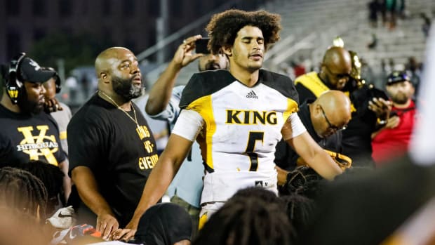 Detroit King quarterback Dante Moore (5) talks to teammates after 28-23 win over Detroit Cass Tech at Cass Technical High School in Detroit on Friday, Sept. 16, 2022.