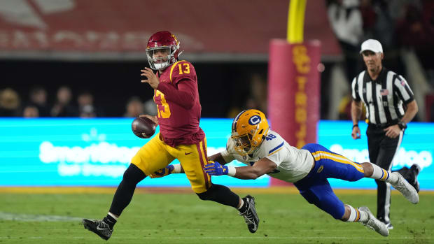 Nov 5, 2022; Los Angeles, California, USA; Southern California Trojans quarterback Caleb Williams (13) is pursued by California Golden Bears linebacker Orin Patu (48) in the first half at United Airlines Field at Los Angeles Memorial Coliseum.