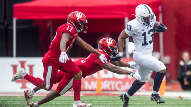 Penn State's Kaytron Allen (13) avoids Indiana's Tiawan Mullen (3) during the first half of the Indiana versus Penn State football game at Memorial Stadium on Satruday, Nov. 5, 2022.