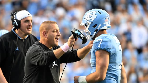 Oct 16, 2021; Chapel Hill, North Carolina, USA; North Carolina Tar Heels quarterback Sam Howell (7) with offensive coordinator Phil Longo after running for a touchdown in the third quarter at Kenan Memorial Stadium.
