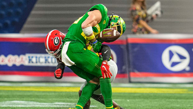 Sep 3, 2022; Atlanta, Georgia, USA; Oregon Ducks wide receiver Chase Cota (23) loses the ball after being hit by Georgia Bulldogs defensive back Christopher Smith (29) during the second half at Mercedes-Benz Stadium. Mandatory Credit: Dale Zanine-USA TODAY Sports