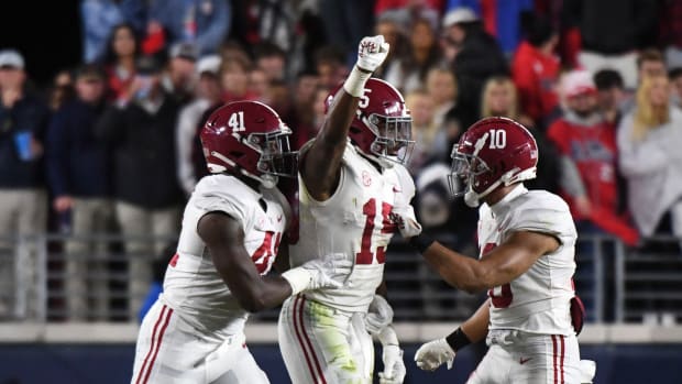 Nov 12, 2022; Oxford, Mississippi, USA; Alabama Crimson Tide linebacker Chris Braswell (41) and linebacker Dallas Turner (15) and linebacker Henry To'o To'o (10) celebrate after making a stop against the Ole Miss Rebels at Vaught-Hemingway Stadium. Alabama won 30-24.