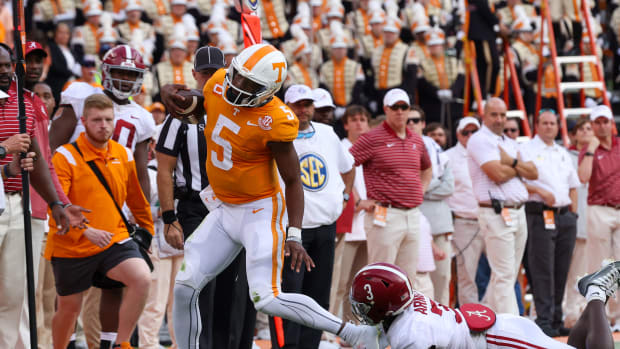 Oct 15, 2022; Knoxville, Tennessee, USA; Tennessee Volunteers quarterback Hendon Hooker (5) is forced out of bounds after a run by Alabama Crimson Tide defensive back Terrion Arnold (3) during the first half at Neyland Stadium.