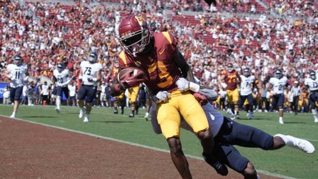 Sep 3, 2022; Los Angeles, California, USA; Southern California Trojans wide receiver Jordan Addison (3) scores a touchdown as Rice Owls cornerback Sean Fresch (1) defends in the first quarter at United Airlines Field at Los Angeles Memorial Coliseum.