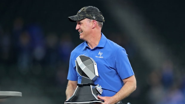 Nov 5, 2022; Arlington, Texas, USA; Air Force Falcons head coach Troy Calhoun celebrates with the Commanders Classic trophy after a win against the Army Black Knights at Globe Life Field.