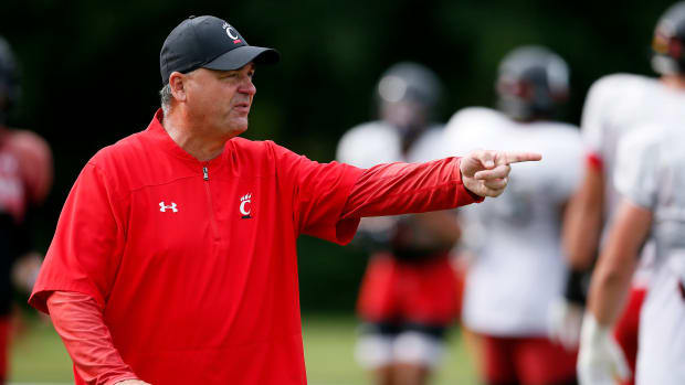 Cincinnati Bearcats offensive coordinator Mike Denbrock directs a drill during practice at the Higher Ground training facility in West Harrison, Ind., on Monday, Aug. 9, 2021. Cincinnati Bearcats Football Camp