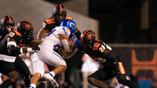 CORVALLIS, OR - SEPTEMBER 03: Boise State Broncos running back George Holani (24) gets tackled by Oregon State Beavers defensive back Kitan Oladapo (28), linebacker Andrew Chatfield Jr. (10), and defensive lineman Thomas Sio (76) at Reser Stadium on September 3, 2022 in Corvallis, Oregon.