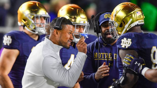 Nov 5, 2022; South Bend, Indiana, USA; Notre Dame Fighting Irish head coach Marcus Freeman talks to defensive lineman Justin Ademilola (9) in the first quarter against the Clemson Tigers at Notre Dame Stadium.