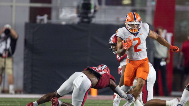 Sep 2, 2022; Bloomington, Indiana, USA; Illinois Fighting Illini running back Chase Brown (2) runs the ball while Indiana Hoosiers defensive lineman Beau Robbins (41) defends in the first quarter at Memorial Stadium.