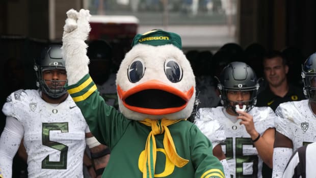 Oct 23, 2021; Pasadena, California, USA; Oregon Ducks mascot Puddles leads players onto the field before the game against the UCLA Bruins Rose Bowl.