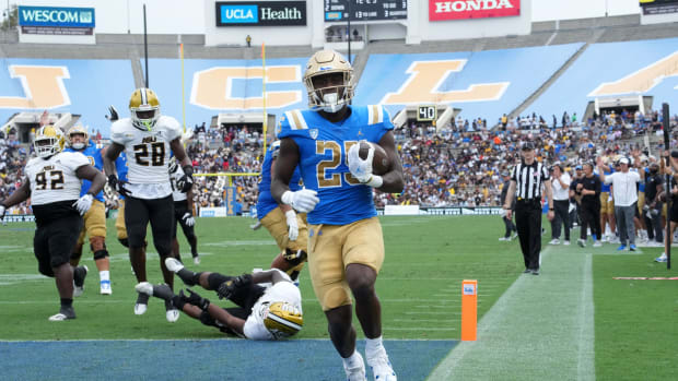 Sep 10, 2022; Pasadena, California, USA; UCLA Bruins running back TJ Harden (25) scores a 13-yard touchdown run in the second half against the Alabama State Hornets at Rose Bowl.