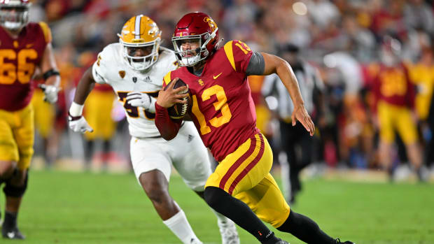 Oct 1, 2022; Los Angeles, California, USA; USC Trojans quarterback Caleb Williams (13) is chased down by Arizona State Sun Devils defensive lineman B.J. Green II (35) as he runs for a first down in the second half at United Airlines Field at the Los Angeles Memorial Coliseum.