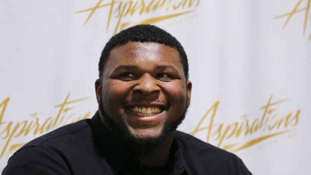 Five-star offensive tackle Kiyaunta Goodwin was all smiles after he made the decision to play football at Kentucky instead of Michigan State during a signing ceremony at the Aspirations gym in Louisville, Ky. on Dec. 15, 2021.