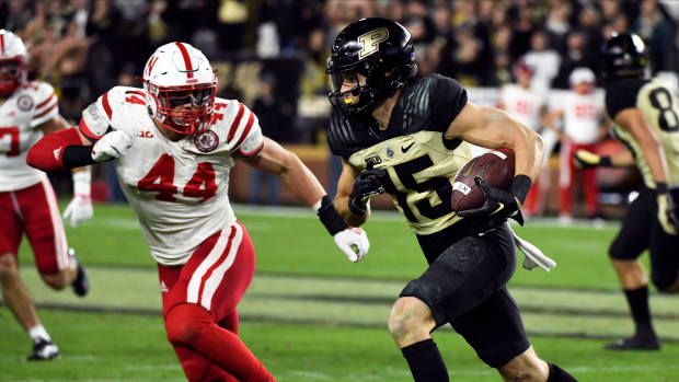 Oct 15, 2022; West Lafayette, Indiana, USA; Purdue Boilermakers wide receiver Charlie Jones (15) runs after a catch past Nebraska Cornhuskers defensive end Garrett Nelson (44) during the second half at Ross-Ade Stadium.