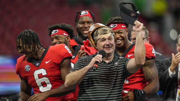 Sep 3, 2022; Atlanta, Georgia, USA; Georgia Bulldogs head coach Kirby Smart reacts with his players after receiving the old leather helmet after Georgia defeated the Oregon Ducks at Mercedes-Benz Stadium. Mandatory Credit: Dale Zanine-USA TODAY Sports