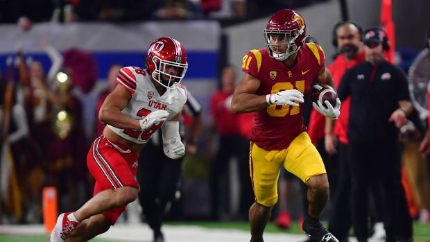 Dec 2, 2022; Las Vegas, NV, USA; Southern California Trojans wide receiver Kyle Ford (81) runs the ball ahead of. Utah Utes safety Sione Vaki (28) during the first half of the PAC-12 Football Championship at Allegiant Stadium.