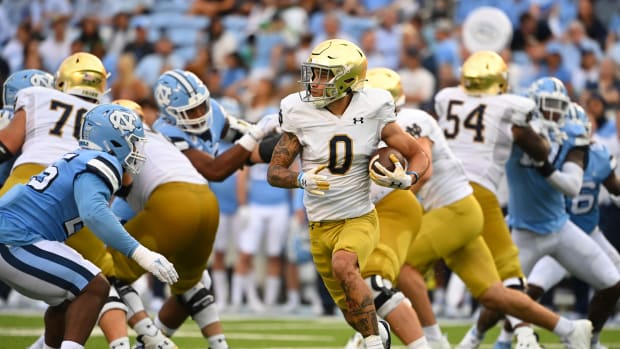 Sep 24, 2022; Chapel Hill, North Carolina, USA; Notre Dame Fighting Irish wide receiver Braden Lenzy (0) with the ball as North Carolina Tar Heels defensive lineman Kaimon Rucker (25) defends in the third quarter at Kenan Memorial Stadium.