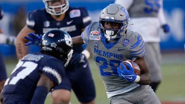 Dec 27, 2022; Dallas, Texas, USA; Memphis Tigers running back Asa Martin (28) runs the ball against Utah State Aggies safety Hunter Reynolds (27) during the second half in the 2022 First Responder Bowl at Gerald J. Ford Stadium.