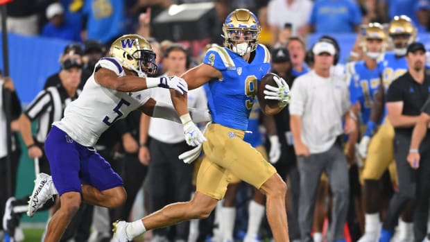Sep 30, 2022; Pasadena, California, USA; UCLA Bruins wide receiver Jake Bobo (9) runs down the sideline for a first down after a complete pass in the first half before he is stopped by Washington Huskies safety Alex Cook (5) in the first half at the Rose Bowl.