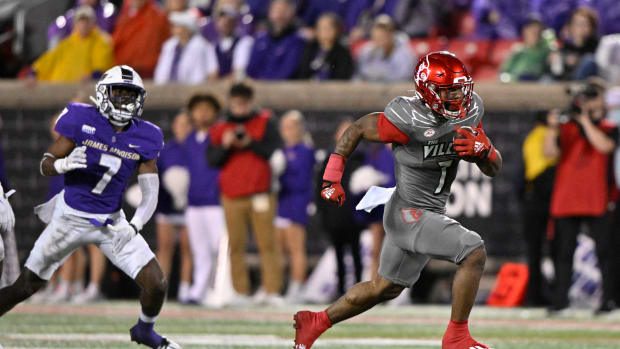 Nov 5, 2022; Louisville, Kentucky, USA; Louisville Cardinals running back Tiyon Evans (7) runs the ball to score a touch down against the James Madison Dukes during the second half at Cardinal Stadium. Louisville defeated James Madison 34-10