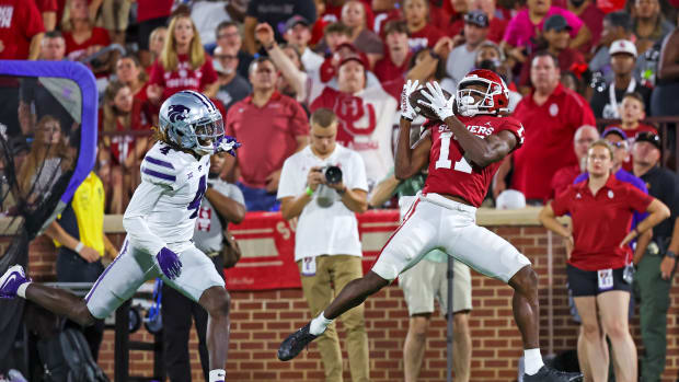 Sep 24, 2022; Norman, Oklahoma, USA; Oklahoma Sooners wide receiver Marvin Mims (17) catches a touchdown pass past Kansas State Wildcats cornerback Omar Daniels (4) during the first half at Gaylord Family-Oklahoma Memorial Stadium.