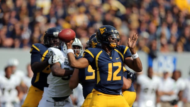 September 29, 2012; Morgantown, WV, USA; West Virginia Mountaineers quarterback Geno Smith (12) drops back to pass in the second half in the game against the Baylor Bears at Milan Puskar Stadium. West Virginia defeated Baylor 70-63.