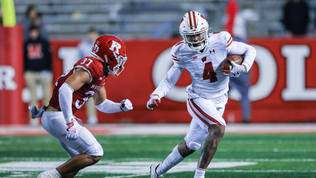 Nov 6, 2021; Piscataway, New Jersey, USA; Wisconsin Badgers wide receiver Markus Allen (4) gains yards after the catch as Rutgers Scarlet Knights defensive back Joe Lusardi (37) pursues during the second half at SHI Stadium.