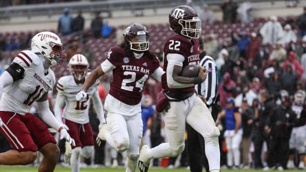 Nov 19, 2022; College Station, Texas, USA; Texas A&M Aggies running back Le'Veon Moss (22) runs with the ball and scores a touchdown during the fourth quarter against the Massachusetts Minutemen at Kyle Field.