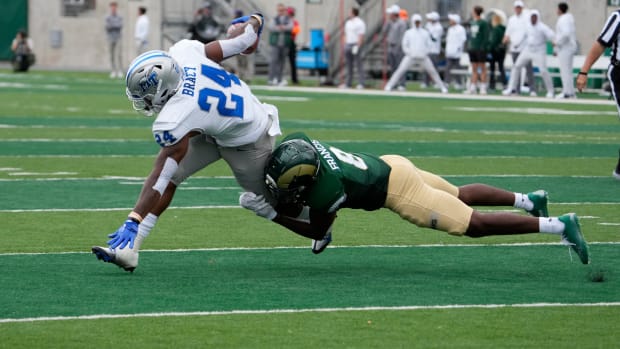 Sep 10, 2022; Fort Collins, Colorado, USA; Middle Tennessee Blue Raiders running back Darius Bracy (24) tries to escape th34t grasp of Colorado State Rams defensive back Tywan Francis (8) at Sonny Lubick Field at Canvas Stadium.