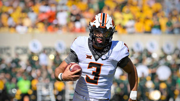 Oct 1, 2022; Waco, Texas, USA; Oklahoma State Cowboys quarterback Spencer Sanders (3) runs for a first down against the Baylor Bears during the first quarter at McLane Stadium.