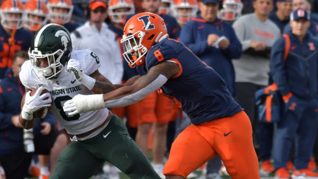 Nov 5, 2022; Champaign, Illinois, USA; Illinois Fighting Illini linebacker Tarique Barnes (8) tries to tackle Michigan State Spartans running back Jalen Berger (8) during the first half at Memorial Stadium.