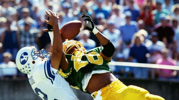 Oregon's Daryle Smith, right, intercepts a pass by BYU's Ty Detmer during the second quarter of their Sept. 29, 1990 matchup at Autzen.
