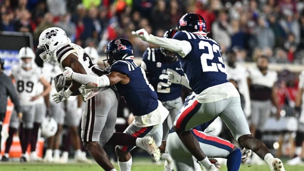 Nov 24, 2022; Oxford, Mississippi, USA;Mississippi State Bulldogs running back Dillon Johnson (23) runs the ball while defended by Ole Miss Rebels linebacker Troy Brown (8) during the second quarter at Vaught-Hemingway Stadium.