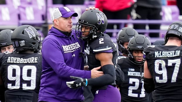 Nov 5, 2022; Evanston, Illinois, USA; Northwestern Wildcats head coach Pat Fitzgerald hugs defensive back Cameron Mitchell (2) during the second half of the NCAA football game at Ryan Field. Ohio State won 21-7.