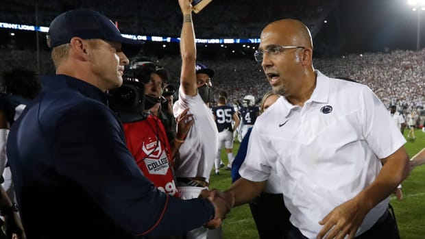 Sep 18, 2021; University Park, Pennsylvania, USA; Penn State Nittany Lions head coach James Franklin (right) shakes hands with Auburn Tigers head coach Bryan Harsin (left) following the competition of the game at Beaver Stadium. Penn State defeated Auburn 28-20.