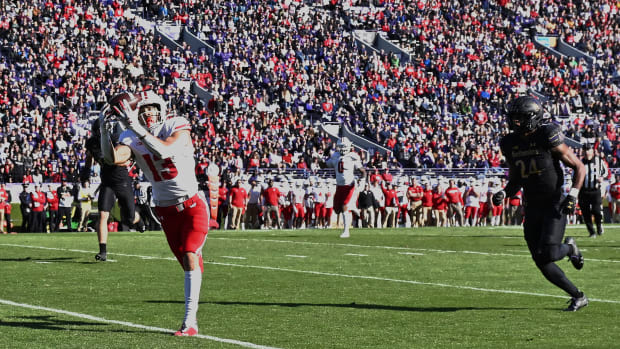 Oct 8, 2022; Evanston, Illinois, USA; Wisconsin Badgers wide receiver Chimere Dike (13) catches a 21-yard touchdown pass in the second quarter in front of Northwestern Wildcats defensive back Rod Heard II (24) at Ryan Field.