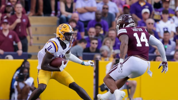 Sep 17, 2022; Baton Rouge, Louisiana, USA; LSU Tigers wide receiver Brian Thomas Jr. (11) runs against Mississippi State Bulldogs linebacker Nathaniel Watson (14) during the first half at Tiger Stadium.
