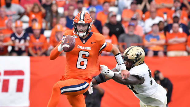 Sep 17, 2022; Syracuse, New York, USA; Syracuse Orange quarterback Garrett Shrader (6) avoids a tackle by Purdue Boilermakers defensive tackle Branson Deen (58) in the third quarter at JMA Wireless Dome.