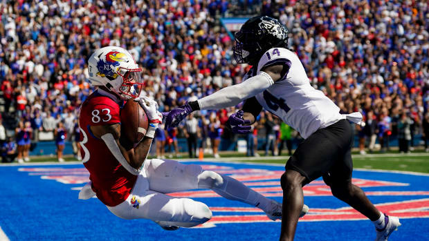 Oct 8, 2022; Lawrence, Kansas, USA; Kansas Jayhawks wide receiver Quentin Skinner (83) catches a touchdown pass against TCU Horned Frogs safety Abraham Camara (14) during the second half at David Booth Kansas Memorial Stadium.